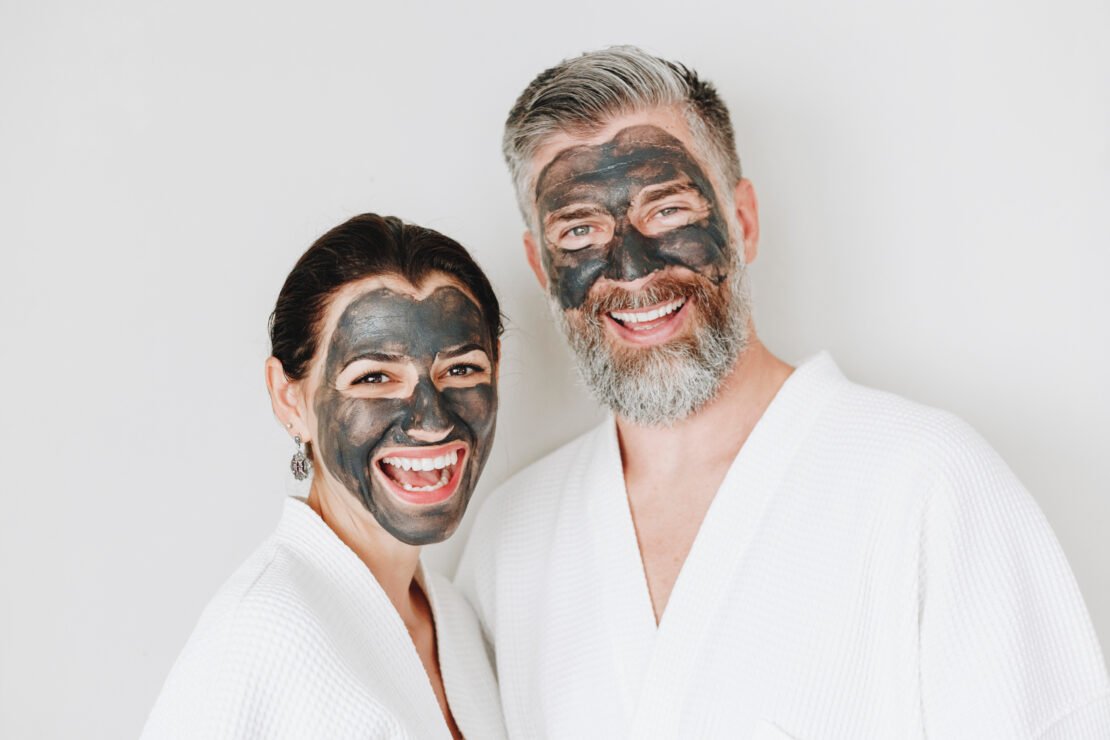 Happy,Couple,Wearing,A,Charcoal,Mask